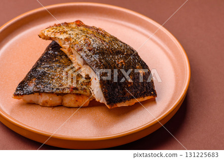 Food, seafood, grilled fish fillet with lemon, salt and spices. Grilled fish fillet Food, seafood, grilled fish fillet with lemon, salt and spices. Grilled fish fillet 131225683