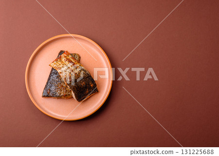 Food, seafood, grilled fish fillet with lemon, salt and spices. Grilled fish fillet Food, seafood, grilled fish fillet with lemon, salt and spices. Grilled fish fillet 131225688