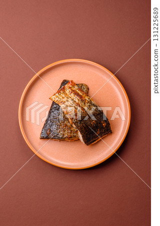 Food, seafood, grilled fish fillet with lemon, salt and spices. Grilled fish fillet Food, seafood, grilled fish fillet with lemon, salt and spices. Grilled fish fillet 131225689