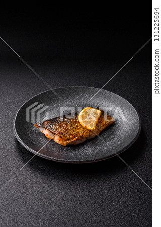 Food, seafood, grilled fish fillet with lemon, salt and spices. Grilled fish fillet 131225694