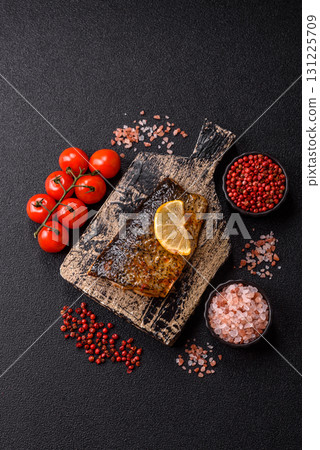 Food, seafood, grilled fish fillet with lemon, salt and spices. Grilled fish fillet Food, seafood, grilled fish fillet with lemon, salt and spices. Grilled fish fillet 131225709