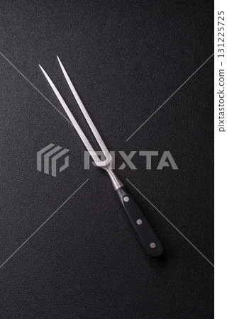 Empty meat or steak fork with vegetables, spices and other ingredients. Meat fork 131225725