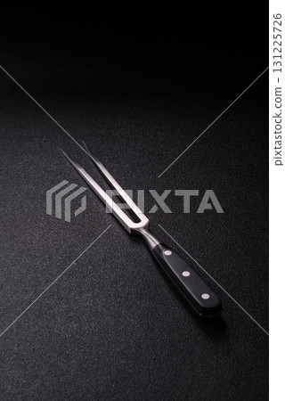 Empty meat or steak fork with vegetables, spices and other ingredients. Meat fork 131225726