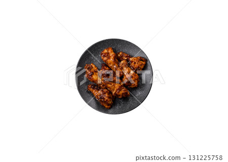 Grilled or barbecued chicken wings with teriyaki sauce, spices and sesame seeds. Teriyaki chicken Grilled or barbecued chicken wings with teriyaki sauce, spices and sesame seeds. Teriyaki chicken 131225758