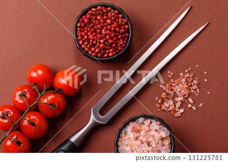 Empty meat or steak fork with vegetables, spices and other ingredients. Meat fork Empty meat or steak fork with vegetables, spices and other ingredients. Meat fork 131225781