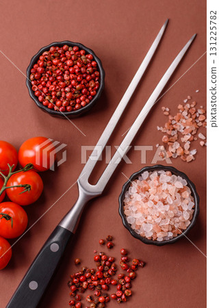 Empty meat or steak fork with vegetables, spices and other ingredients. Meat fork Empty meat or steak fork with vegetables, spices and other ingredients. Meat fork 131225782