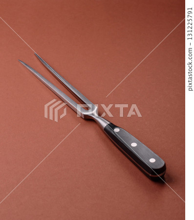 Empty meat or steak fork with vegetables, spices and other ingredients. Meat fork 131225791