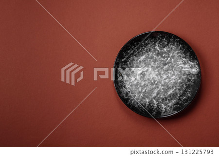 Empty round black plate for food, kitchen utensils on dining table. Empty plate Empty round black plate for food, kitchen utensils on dining table. Empty plate 131225793