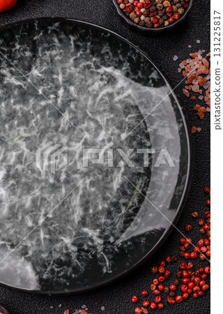 Empty round black plate for food, kitchen utensils on dining table. Empty plate Empty round black plate for food, kitchen utensils on dining table. Empty plate 131225817