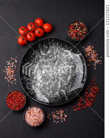 Empty round black plate for food, kitchen utensils on dining table. Empty plate 131225821