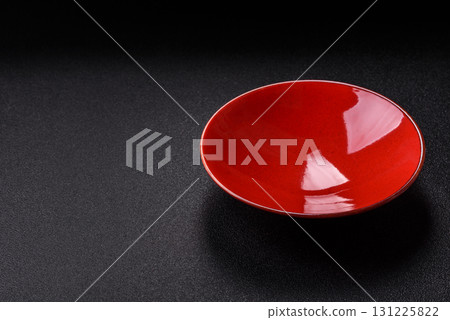 Empty round black plate for food, kitchen utensils on dining table. Empty plate Empty round black plate for food, kitchen utensils on dining table. Empty plate 131225822