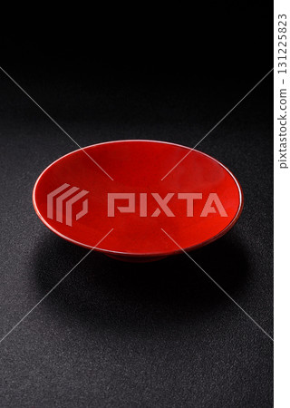 Empty round black plate for food, kitchen utensils on dining table. Empty plate Empty round black plate for food, kitchen utensils on dining table. Empty plate 131225823