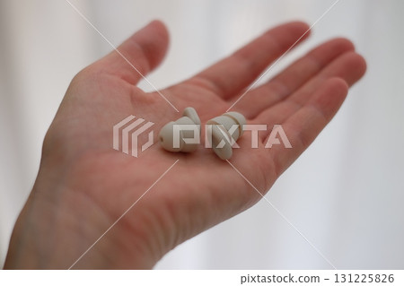 Earplugs in the palm of your hand 131225826