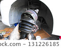 Worn CV axle joint with damaged rubber boot and visible grease leakage 131226185