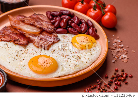 Fried egg, bacon and beans, a classic British breakfast with tomatoes. Egg, bacon and beans 131226469