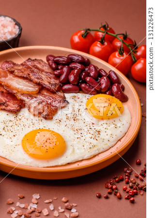 Fried egg, bacon and beans, a classic British breakfast with tomatoes. Egg, bacon and beans 131226473