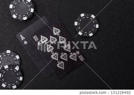 Playing blackjack or baccarat card game in casino with chips, bets and risk. Cards and chips Playing blackjack or baccarat card game in casino with chips, bets and risk. Cards and chips 131226492