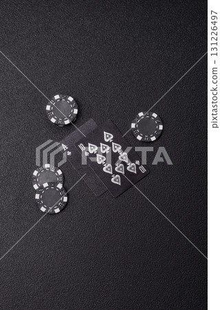 Playing blackjack or baccarat card game in casino with chips, bets and risk. Cards and chips 131226497