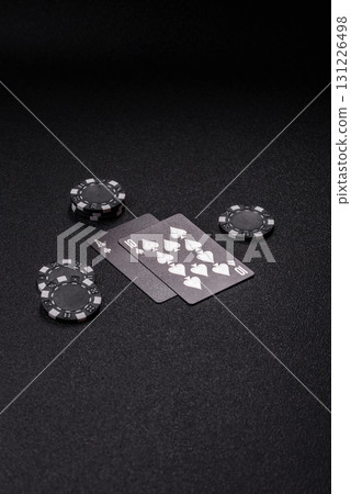 Playing blackjack or baccarat card game in casino with chips, bets and risk. Cards and chips 131226498
