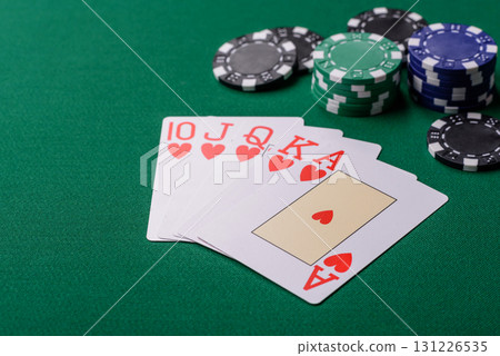 Playing card game poker in casino with chips, bets and risk. Cards and chips on elt Playing card game poker in casino with chips, bets and risk. Cards and chips on elt 131226535