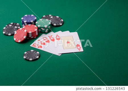 Playing card game poker in casino with chips, bets and risk. Cards and chips on elt Playing card game poker in casino with chips, bets and risk. Cards and chips on elt 131226543