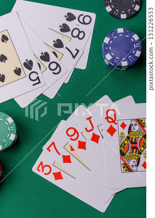 Playing card game poker in casino with chips, bets and risk. Cards and chips on elt Playing card game poker in casino with chips, bets and risk. Cards and chips on elt 131226553