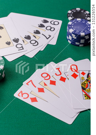 Playing card game poker in casino with chips, bets and risk. Cards and chips on elt Playing card game poker in casino with chips, bets and risk. Cards and chips on elt 131226554