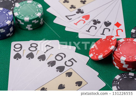 Playing card game poker in casino with chips, bets and risk. Cards and chips on elt Playing card game poker in casino with chips, bets and risk. Cards and chips on elt 131226555