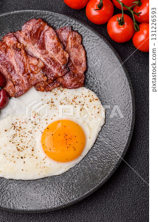 Fried egg, bacon and beans, a classic British breakfast with tomatoes. Egg, bacon and beans 131226593