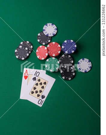 Playing blackjack or baccarat card game in casino with chips, bets and risk. Cards and chips on felt Playing blackjack or baccarat card game in casino with chips, bets and risk. Cards and chips on felt 131226662