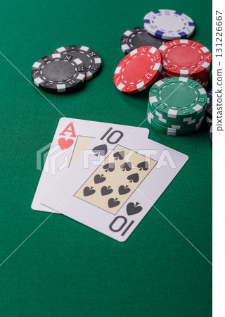 Playing blackjack or baccarat card game in casino with chips, bets and risk. Cards and chips on felt Playing blackjack or baccarat card game in casino with chips, bets and risk. Cards and chips on felt 131226667