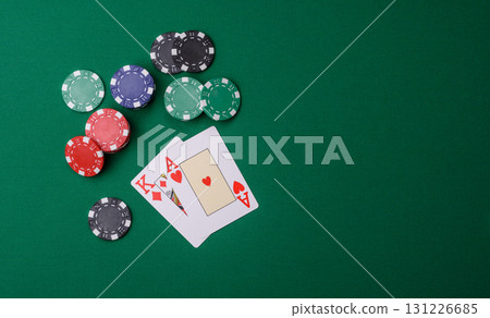Playing blackjack or baccarat card game in casino with chips, bets and risk. Cards and chips on felt 131226685