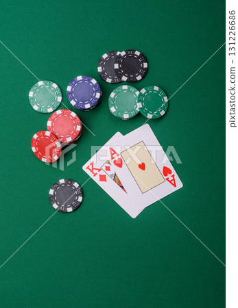 Playing blackjack or baccarat card game in casino with chips, bets and risk. Cards and chips on felt Playing blackjack or baccarat card game in casino with chips, bets and risk. Cards and chips on felt 131226686
