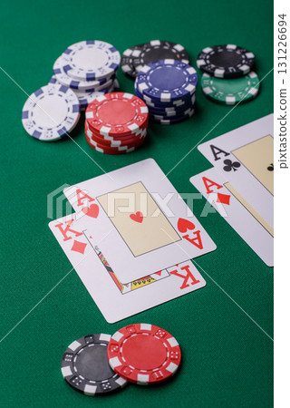 Playing blackjack or baccarat card game in casino with chips, bets and risk. Cards and chips on felt Playing blackjack or baccarat card game in casino with chips, bets and risk. Cards and chips on felt 131226694
