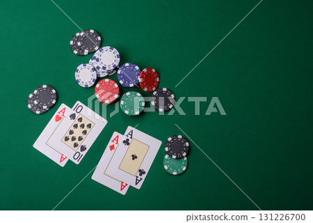Playing blackjack or baccarat card game in casino with chips, bets and risk. Cards and chips on felt 131226700