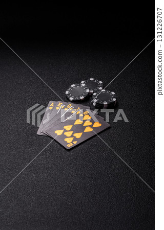 Playing card game poker in casino with chips, bets and risk. Cards and chips on elt 131226707