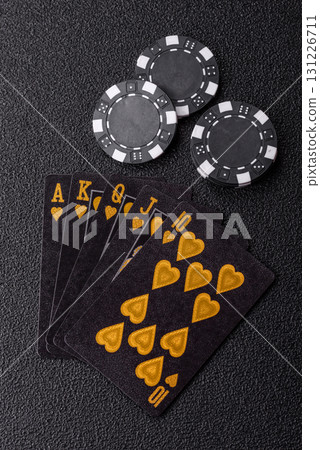 Playing card game poker in casino with chips, bets and risk. Cards and chips on elt 131226711