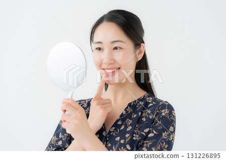 Woman looking in the mirror dental Woman looking in the mirror dental 131226895