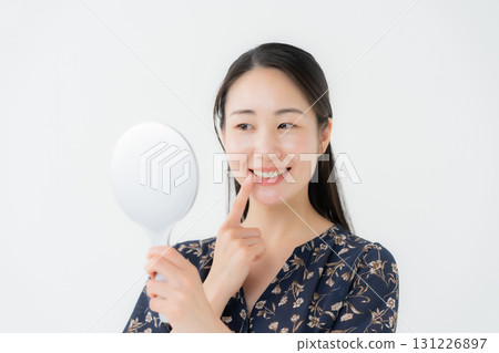 Woman looking in the mirror dental Woman looking in the mirror dental 131226897