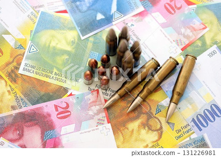 Swiss franc banknotes and bullets. The current francs money bills and ammo lies on table 131226981