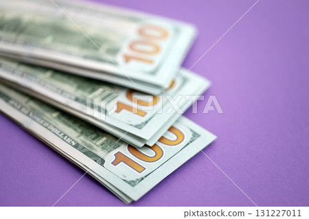 Big amount of United States hundred dollar bills on purple background 131227011