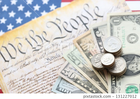American US dollars money bills with coins and constitution close up on american flag 131227012