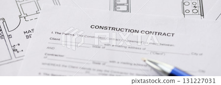 Pen on residential construction agreement and planning blueprints of residential building project 131227031