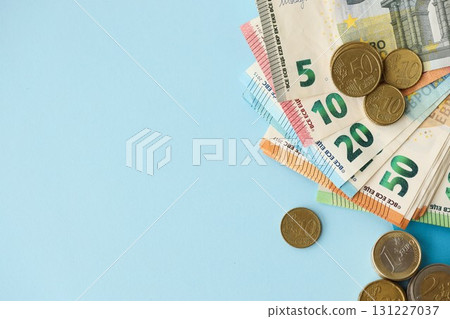 European union Euro money bills and coins on blue table 131227037