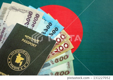 Bangladeshi taka money bills in big amount and passport lies on Bangladesh flag close up 131227052