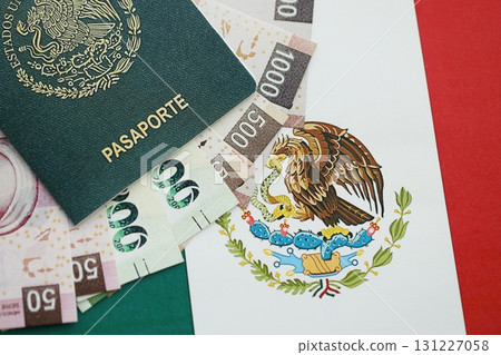 Mexican pesos money bills in big amount and passport lies on Mexico flag close up 131227058