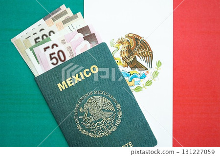 Mexican pesos money bills in big amount and passport lies on Mexico flag close up 131227059