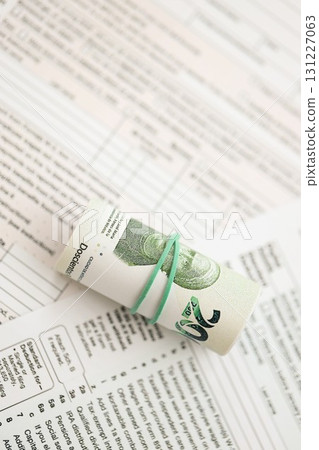 Mexican pesos money bills in big amount lies on table with tax forms close up 131227063