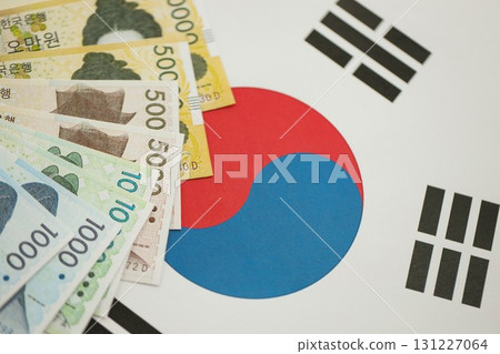 South Korean won money bills in big amount lies on South Korea flag close up 131227064