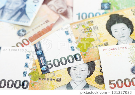 South Korean won money bills in big amount lies on white color table close up South Korean won money bills in big amount lies on white color table close up 131227083